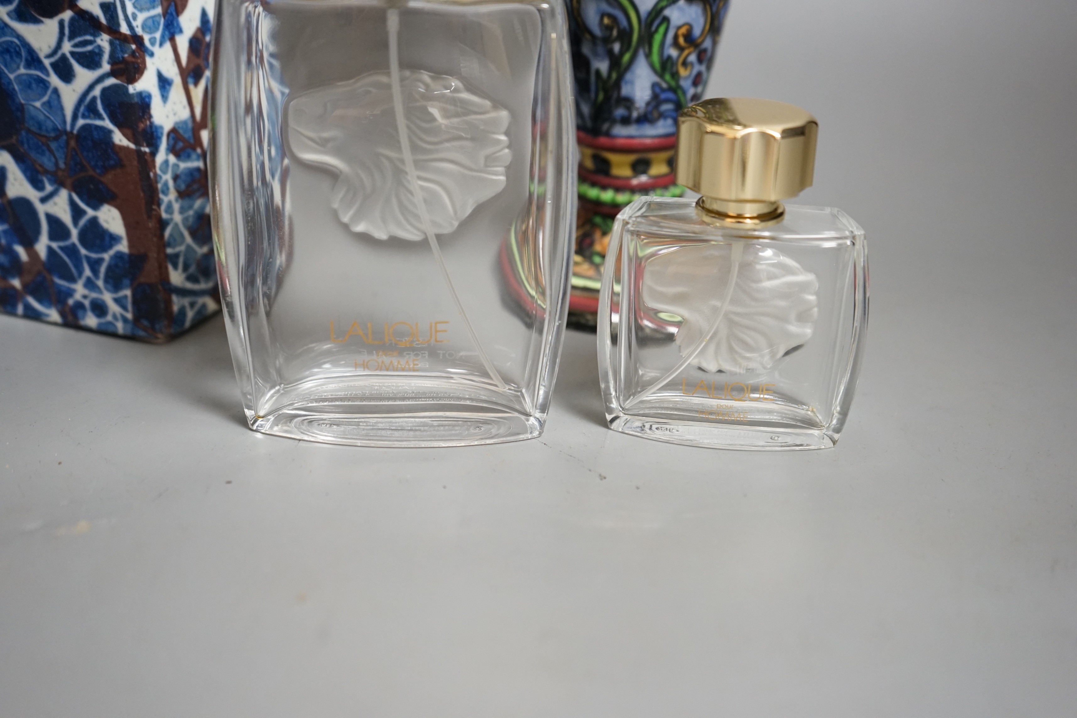 A Royal Copenhagen faience vase and a grotesque style bottle vase and two Lalique pour Homme perfume bottles, faience vase 23cms high